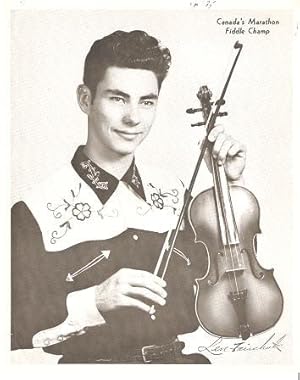 PROFESSIONAL PHOTOGRAPH OF THE YOUNG LEN FAIRCHUK IN AN EMBROIDERED WESTERN SHIRT, HOLDING HIS FI...