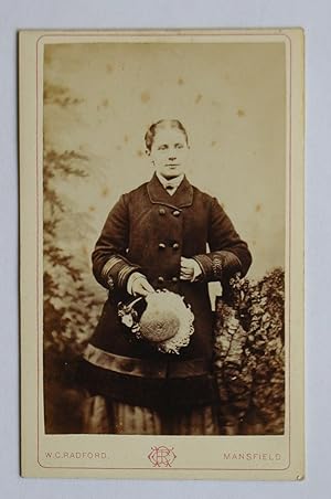 Seller image for Carte De Visite Photograph. Studio Portrait of a Young Woman Wearing a Coat & Holding a Hat. for sale by N. G. Lawrie Books
