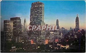 Image du vendeur pour Carte Postale Moderne Night Falls on Midtown Manhattan Showing RCA Building Chrysler Building and Empire State Building mis en vente par CPAPHIL