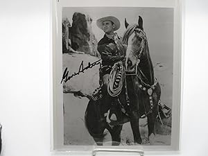 Bild des Verkufers fr 8x10 signed black and white photograph of Gene Autry, "America's favorite singing cowboy", on horseback. zum Verkauf von Zephyr Books