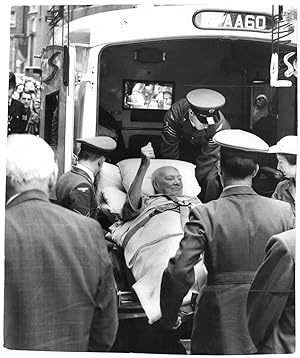 An original press photo of Sir Winston S. Churchill being lifted out of the ambulance at Middlese...