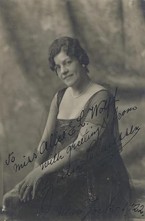 Three-quarter length photograph of the noted Swedish mezzo-soprano, seated, in formal dress. Sign...