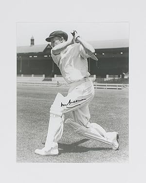 A signed photograph (black and white, 253 × 203 mm) of Don Bradman executing a cover drive