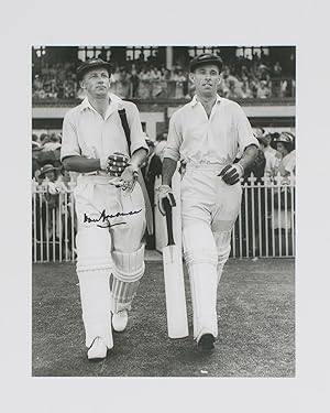 A signed photograph of Don Bradman walking out to bat with Jack Fingleton