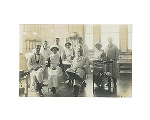 A vintage photograph of a hospital operating theatre, complete with nine doctors and nurses - and...