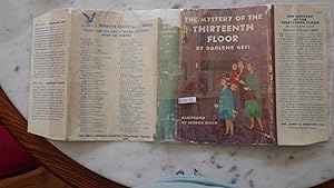 Seller image for The Mystery Of The Thirteenth Floor by Darlene Geis, 1st Edition Stated, in Brown, BLUE & GREEN DJ with Family & Children Outside Fancy NY SKYSCRAPER Apt. Building with Doorman ,Illustrated by Georgia Bloch. for sale by Bluff Park Rare Books