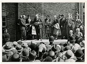 An original press photograph of Winston S. Churchill on stage for the announcement of his Parliam...