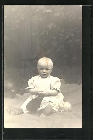 Ansichtskarte Kleines Mädchen sitzt mit seiner Puppe auf einer Decke im Garten