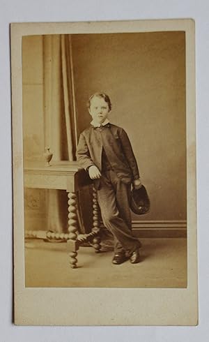 Bild des Verkufers fr Carte De Visite Photograph: A Studio Portrait of a Young Boy Holding a Cap. zum Verkauf von N. G. Lawrie Books