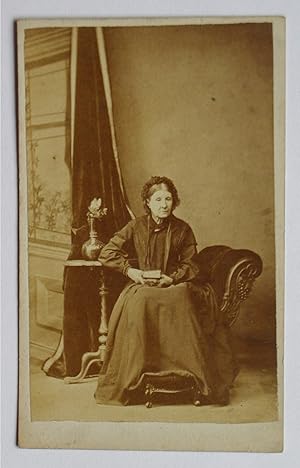 Bild des Verkufers fr Carte De Visite Photograph. Studio Portrait of Seated Lady Holding a Book. zum Verkauf von N. G. Lawrie Books