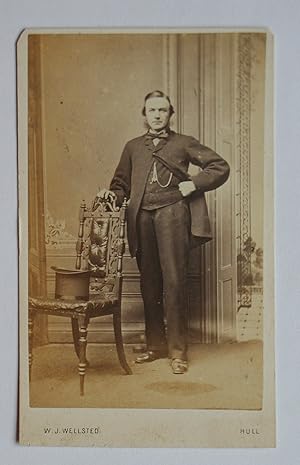 Carte De Visite Photograph: A Studio Portrait of a Gentleman Beside a Chair with a Top Hat.