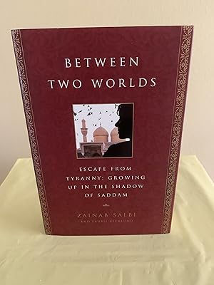 Imagen del vendedor de Between Two Worlds: Escape From Tyranny: Growing Up in the Sahdow of Saddam [FIRST EDITION, FIRST PRINTING] a la venta por Vero Beach Books