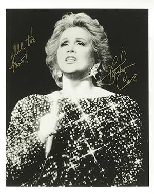 Half-length photograph of the American actress and singer holding microphone, inscribed "All the ...