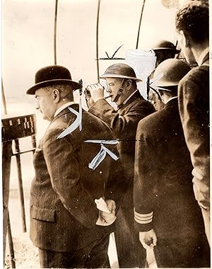 A wartime press photograph of British Prime Minister Winston S. Churchill, accompanied by his clo...