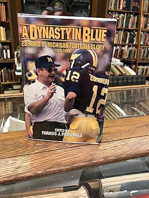 Imagen del vendedor de A DYNASTY IN BLUE, 25 Years of Michigan Football Glory (1969-1994) a la venta por John K King Used & Rare Books