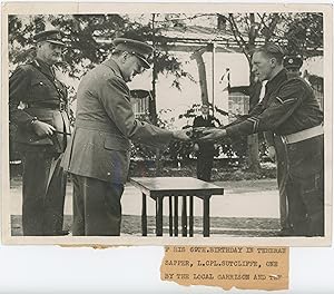 A British Official wartime press photograph of Prime Minister Winston S. Churchill receiving a gi...
