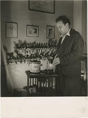 Original photograph of Arthur Honegger filling his pipe, circa 1940s