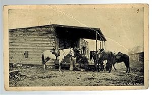 (Real Photo postcard) Cowboys with Horses and Store