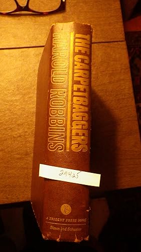 Seller image for The Carpetbaggers by Harold Robbins , SIGNED, 1961 book MADE INTO movie film, BASED ON HOWARD HUGHES, The story of a millionaire who was soft enough to buy a film company because of one woman and hard enough to make more millions after she died. for sale by Bluff Park Rare Books