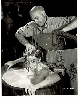 A VINTAGE PUBLICITY PHOTOGRAPH of director CECIL B. DeMILLE giving the beautiful Hollywood Star P...