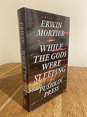 Seller image for While the Gods Were Sleeping >>>> A SUPERB SIGNED & DATED UK FIRST EDITION & FIRST PRINTING HARDBACK <<<< for sale by Zeitgeist Books