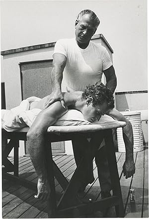 Bild des Verkufers fr Arrowhead (Original oversize photograph of Charlton Heston receiving a massage on the set of the 1953 film) zum Verkauf von Royal Books, Inc., ABAA