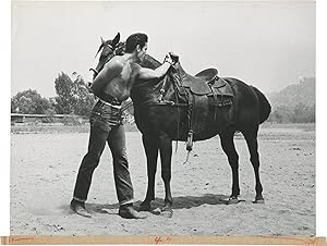 Bild des Verkufers fr Three Violent People (Original photograph of actor Tom Tryon mounting a horse on the set of the 1957 film) zum Verkauf von Royal Books, Inc., ABAA