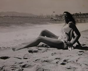 Miss Festival sitting on the beach.Photograph from the 1970 Cannes Film Festival.