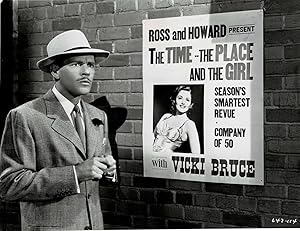 Imagen del vendedor de A VINTAGE PUBLICITY PHOTOGRAPH for Warner Bros, "The Time, The Place and The Girl" portraying DONALD WOODS in front of a poster of MARTHA VICKERS in a scene from the film. a la venta por Blue Mountain Books & Manuscripts, Ltd.