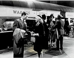 Immagine del venditore per A VINTAGE CONTINUITY LAYOUT PHOTOGRAPH depicting GINGER ROGERS and JEAN-PIERRE AUMONT at the train station in a scene from "HEARTBEAT". venduto da Blue Mountain Books & Manuscripts, Ltd.