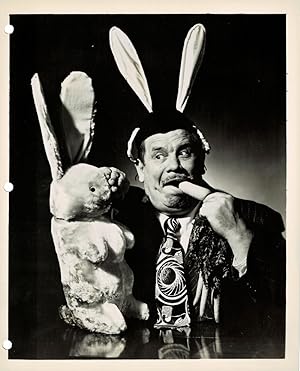 Seller image for A VINTAGE PUBLICITY PHOTOGRAPH for ABC's Radio Quiz Show "DETECT AND COLLECT" featuring funnyman LEW LEHR, here portrayed fending off a stuffed rabbit. for sale by Blue Mountain Books & Manuscripts, Ltd.