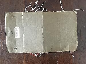 20 swatches of kitchen towel fabric , stapled in brown paper with small label