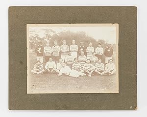 A vintage photograph of an early unidentified Australian Rules Football team, featuring three Ind...