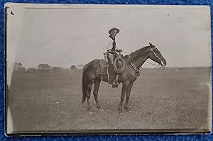 ARMED COWBOY ON HORSE PHOTO