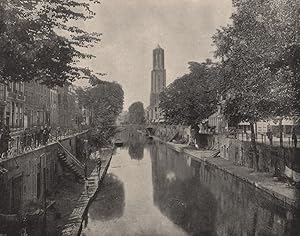 Utrecht - A typical view on one of the old canals: Clock Tower in the distance