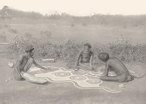 Image du vendeur pour Preparing a ground drawing - In connection with some of the totemic ceremonies of the warramunga tribe drawings are made on the ground. These drawing are sacred and may not be seen by women, In this case the ceremony is connected with the black-snake totem, and the wavy outline of the snake may be seen in the unfinished drawing mis en vente par Antiqua Print Gallery