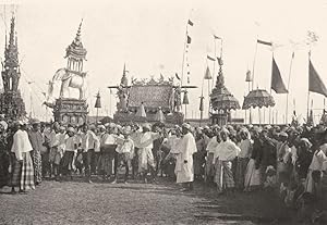 Seller image for A Funeral procession - Now that the Burmese are able not only to make but to keep money for themselves, the offerings which appear on festive occasions and in processions steadily become more and more elaborate. White elephants with theins on their backs, garish umbrellas and various fantastical things, in addition to flags of all colours, tend to appear more and more for sale by Antiqua Print Gallery