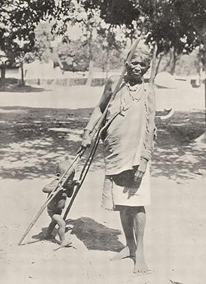 Bild des Verkufers fr A Benares coolie - This woman from Benares, who, as is apparent from her coarse features and broad nose, is one of the menial castes who are day-labourers, is teaching the child to walk by making it hold on to a pair of rude stilts zum Verkauf von Antiqua Print Gallery