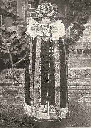 Seller image for Bridal Attire, Buckeburg - Some of the bridal costumes that have been handed down from mother to daughter in rural Germany are reminiscent of medieval feudal days and Gothic altar images. The head-dress is a massive wreath of flowers and berries (or grapes), most likely a pagan attribute of productivity and fruitfulness for sale by Antiqua Print Gallery