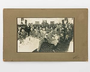 An original photograph of a large group of people, including Australian officers in uniform, at a...