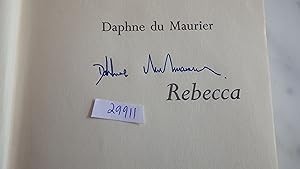 Bild des Verkäufers für REBECCA BY DAPHNE du MAURIER , HAND SIGNED BY AUTHOR on Half Title Pg ,Vintage 1938 Edition,it is a Great Collectible, INNER DJ FLAP $5.95 , in Color Dustjacket COUPLE WALKING UP TO BIG HOUSE Manderley On Water ,Country House in England. . with small sticker on dj Spine, zum Verkauf von Bluff Park Rare Books
