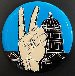 [Pinback button depicting raised hand giving a peace sign outside the capitol]