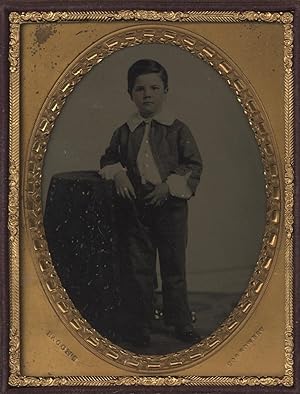 A SUPERB, QUARTER PLATE AMBROTYPE PHOTOGRAPH OF A YOUNG BOY WITH SUBTLE HAND-TINTING AND EMBELLIS...