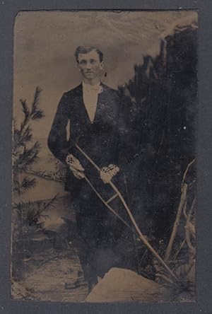 Image du vendeur pour Standing pointy-chinned young man holding a cructh tintype 1860s mis en vente par The Jumping Frog