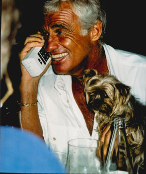 Original large format close-up color photograph of Jean Paul Belmondo with his dog at Cannes.