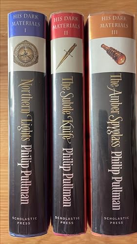 Seller image for Northern Lights, The Subtle Knife, The Amber Spyglass. A set of flat-signed UK first / first thus of the 10th anniversary issue of the Dark Materials Trilogy. for sale by Signed and Delivered Books