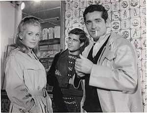 Bild des Verkufers fr The Umbrellas of Cherbourg [Les Parapluies de Cherbourg] (Original photograph of Catherine Deneuve, Jacques Demy, and Nino Castelnuovo on the set of the 1964 French film) zum Verkauf von Royal Books, Inc., ABAA