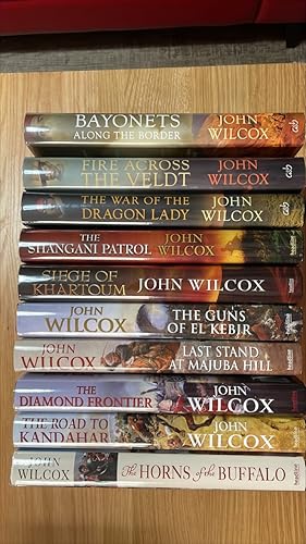 Imagen del vendedor de The Horns of the Buffalo, The Road to Kandahar, The Diamond Frontier, Last Stand at Majuba Hill, The Guns of el Kebir, The Siege of Khartoum, The Shangani Patrol, The War of the Dragon Lady, Fire Across the Veldt, Bayonets Along the Border. Signed UK first editions, first printings of the first 10 Simon Fonthill novels. 5 are also lined / inscribed and 3 are numbered, limited editions. The collection overall is in near fine / near fine condition and each individual book is VG+ or better. a la venta por Signed and Delivered Books