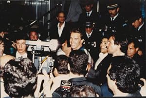 Original large format close-up color photograph of Arnold Schwarzenegger surrounded by entourage ...