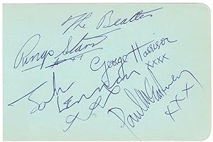 Signed album page by the four members of the Beatles.